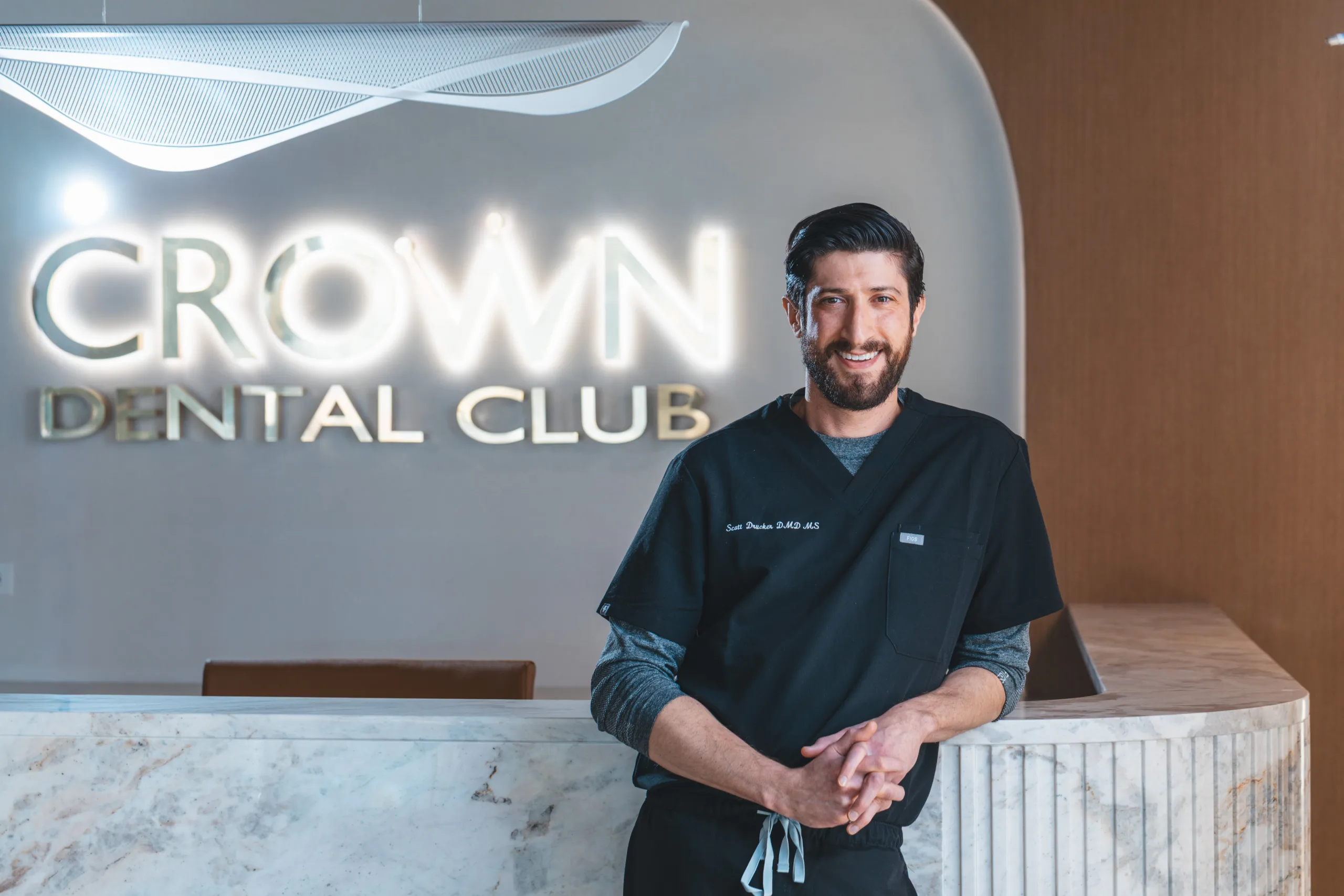 Dr. Scott Drucker at the Crown Dental Club reception desk