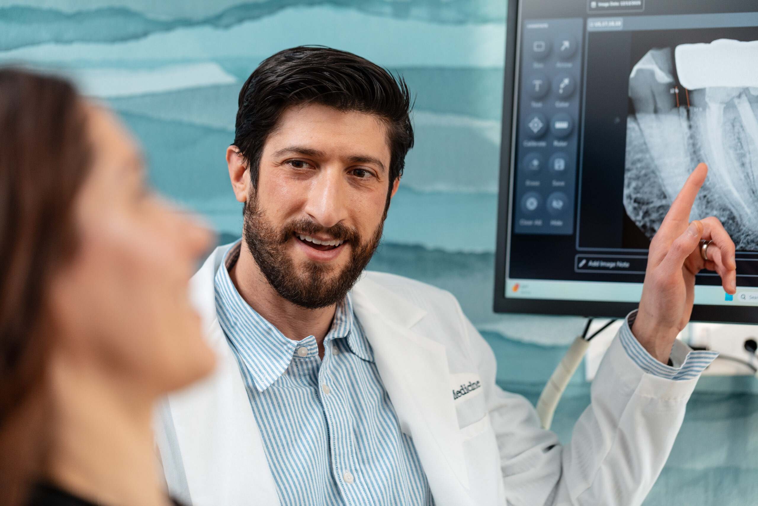 Dr. Scott Drucker reviewing dental imaging during a dental second opinion consultation